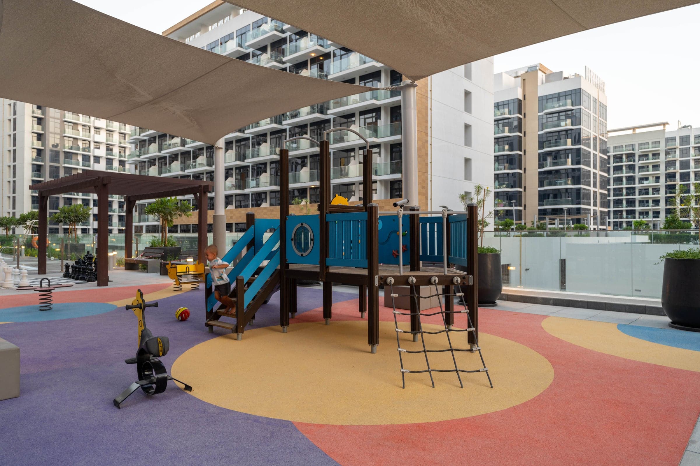 Sunny playground and courtyard among apartment buildings in a Dubai residential community