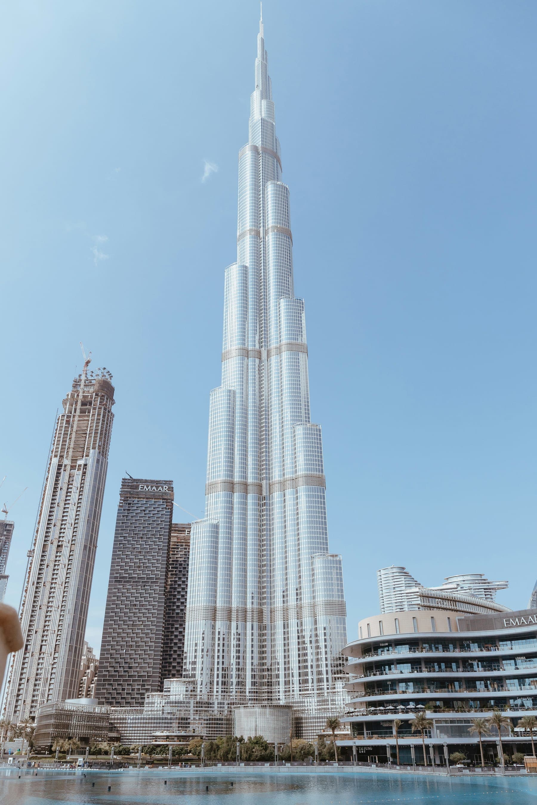 Burj Khalifa rising above the Burj Lake in Downtown Dubai on a clear day