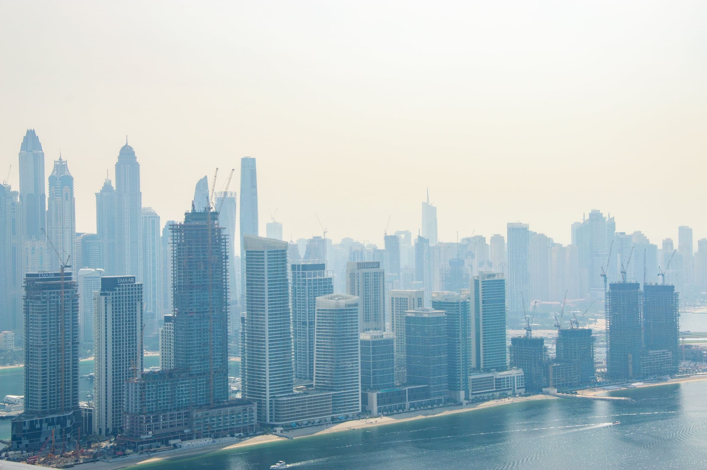 The Emaar Beachfront towers on the Dubai Harbour waterfront, with the Dubai Marina skyline behind