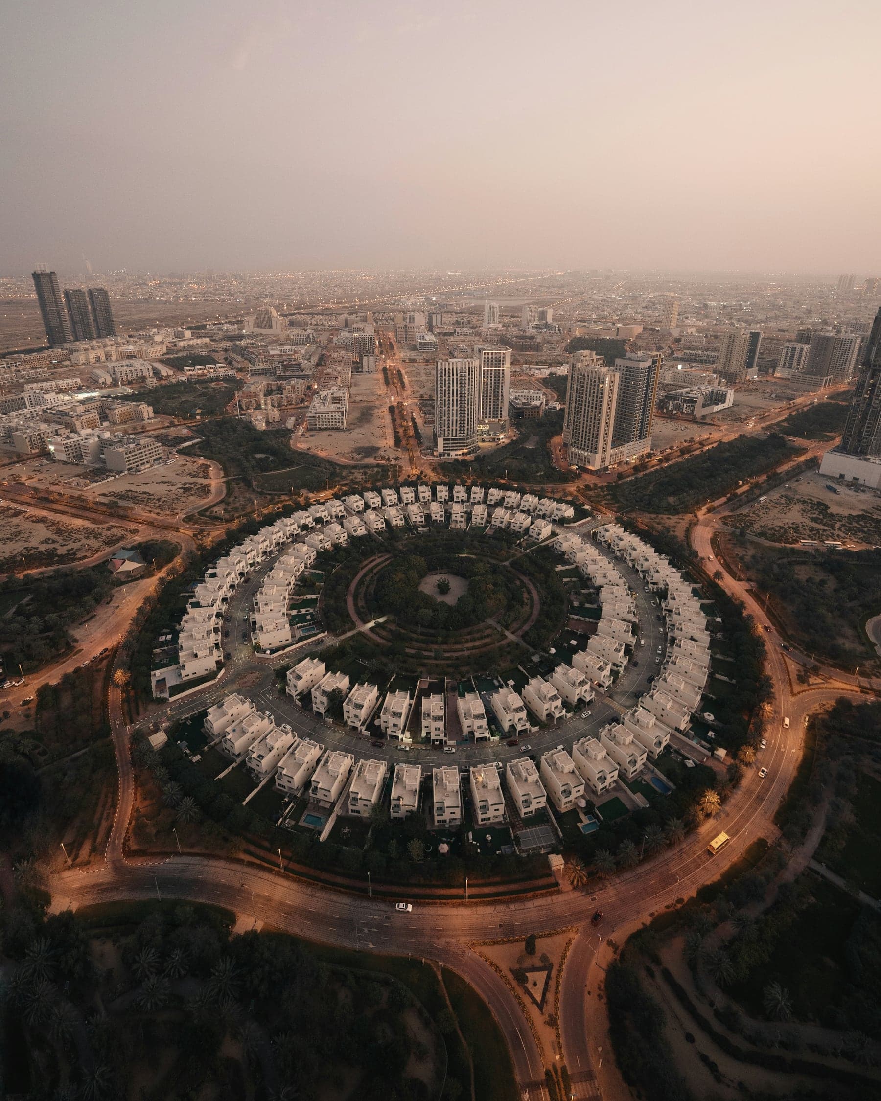 Aerial view of the circular villa cluster at the heart of Jumeirah Village Circle at dusk