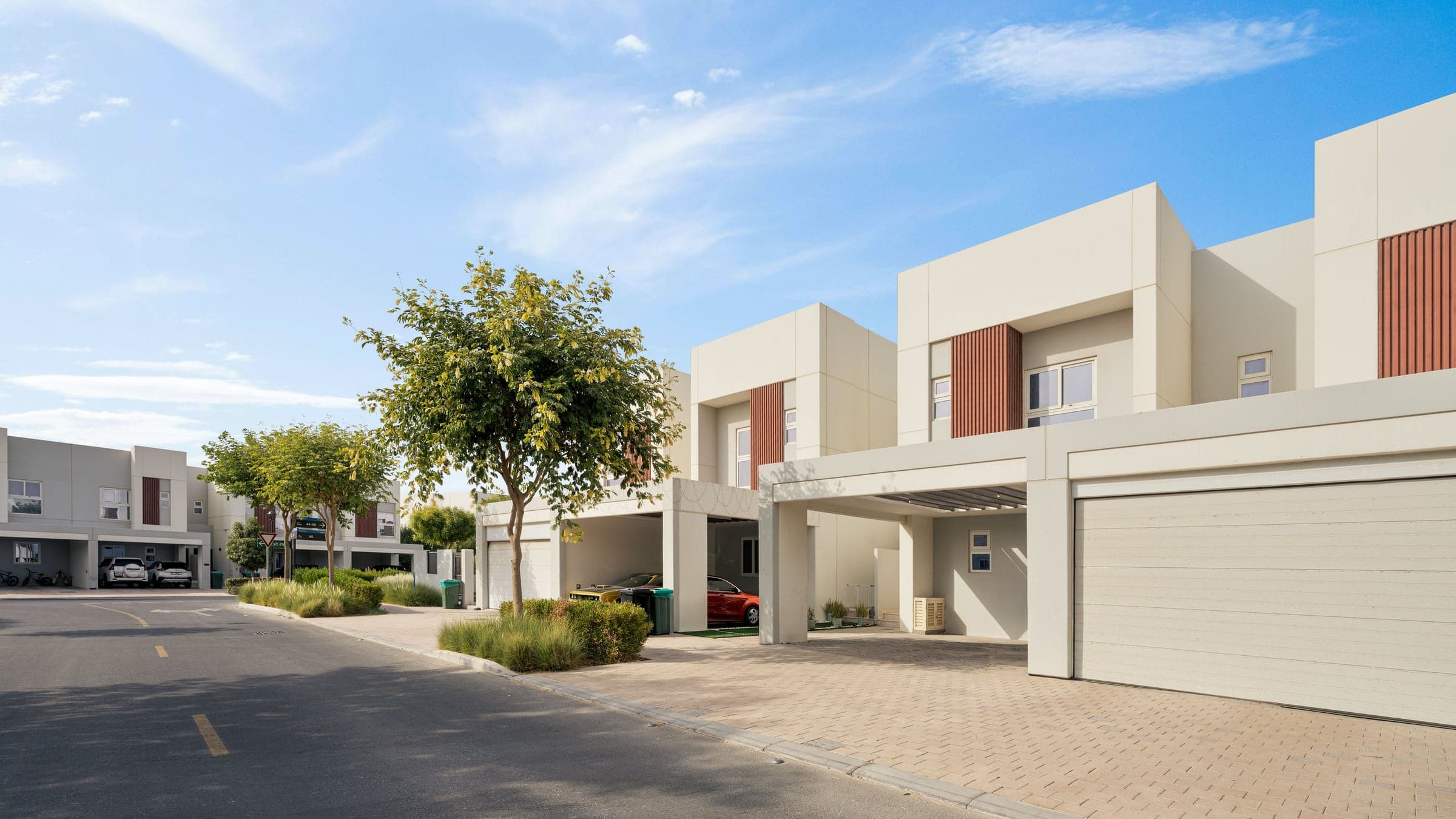 Contemporary townhouses on a quiet, tree lined Dubai street