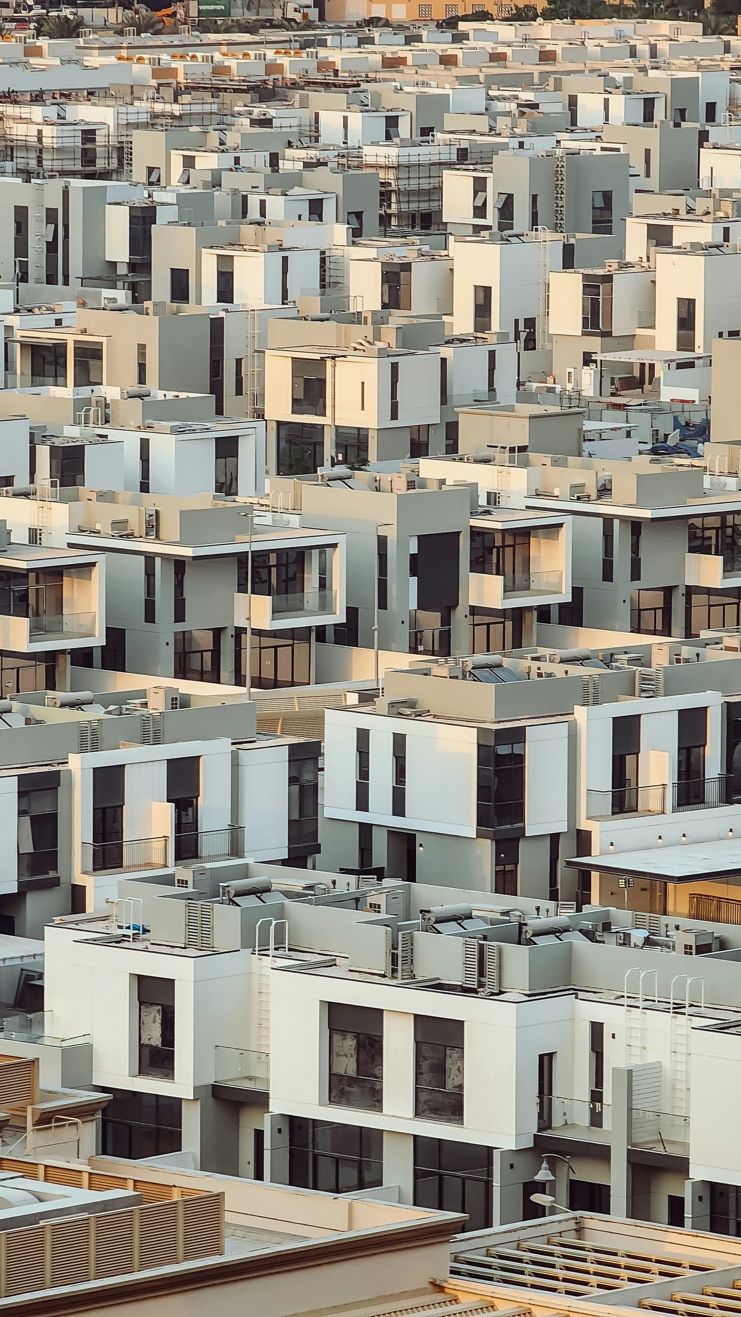 Rows of contemporary white townhouses in a Dubai residential community