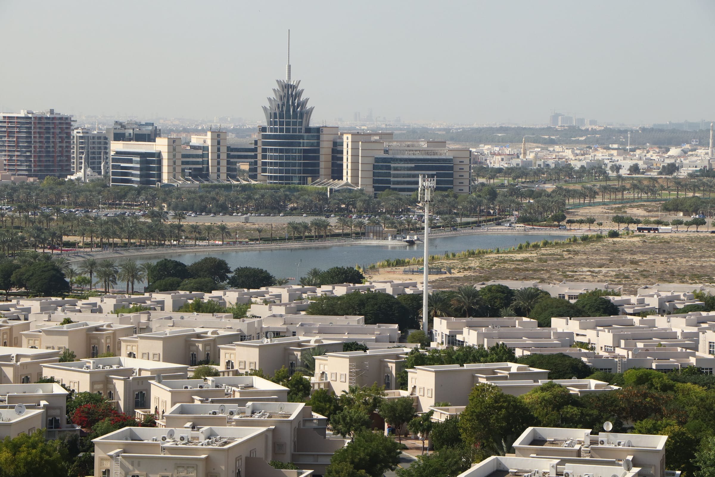 Villas of Dubai Silicon Oasis beside the lake, with the DSO headquarters tower behind