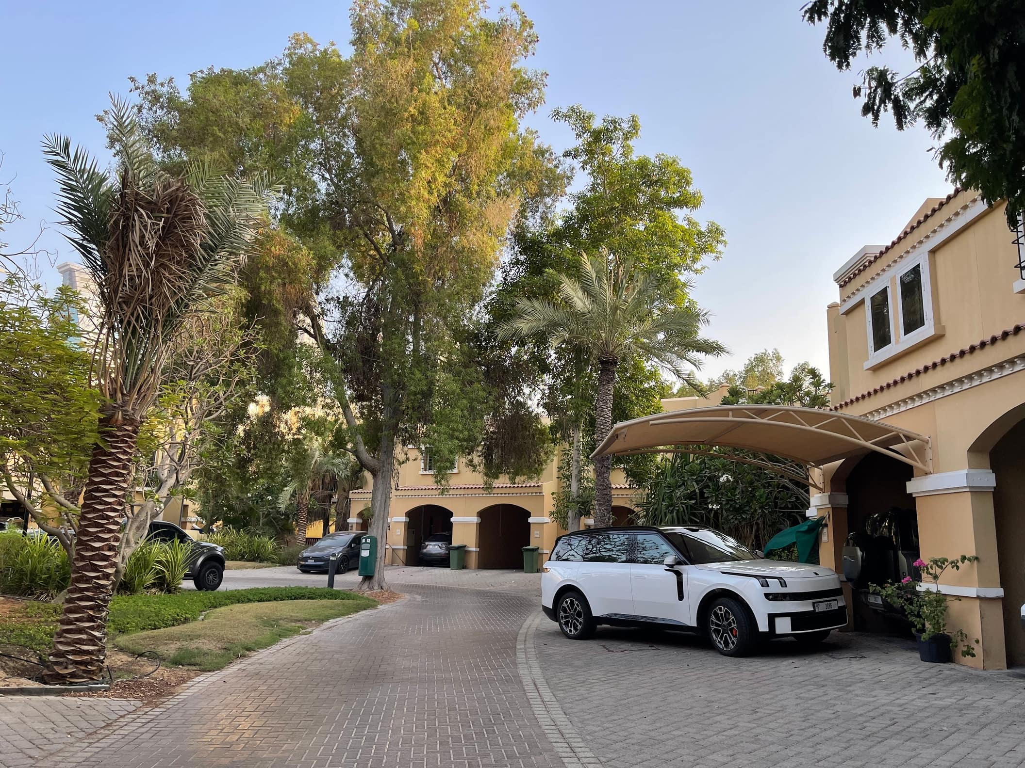 Mediterranean style villa with a palm shaded driveway in a Dubai community