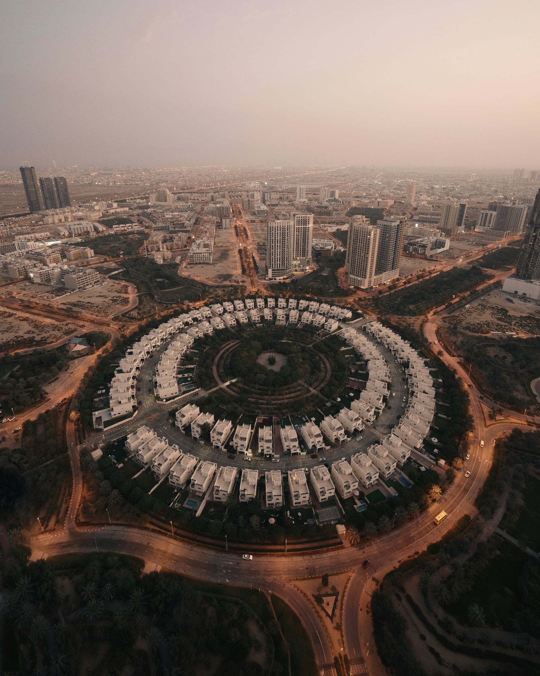 Aerial view of the circular villa cluster at the heart of Jumeirah Village Circle at dusk