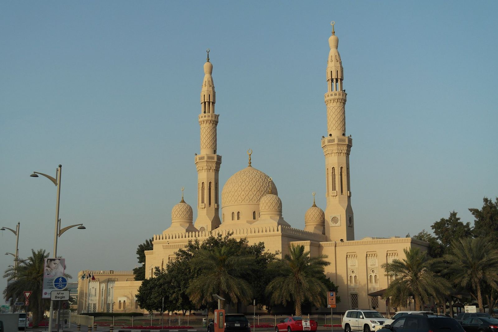 Jumeirah Mosque with its twin minarets and domes in the Jumeirah district of Dubai, framed by palm trees