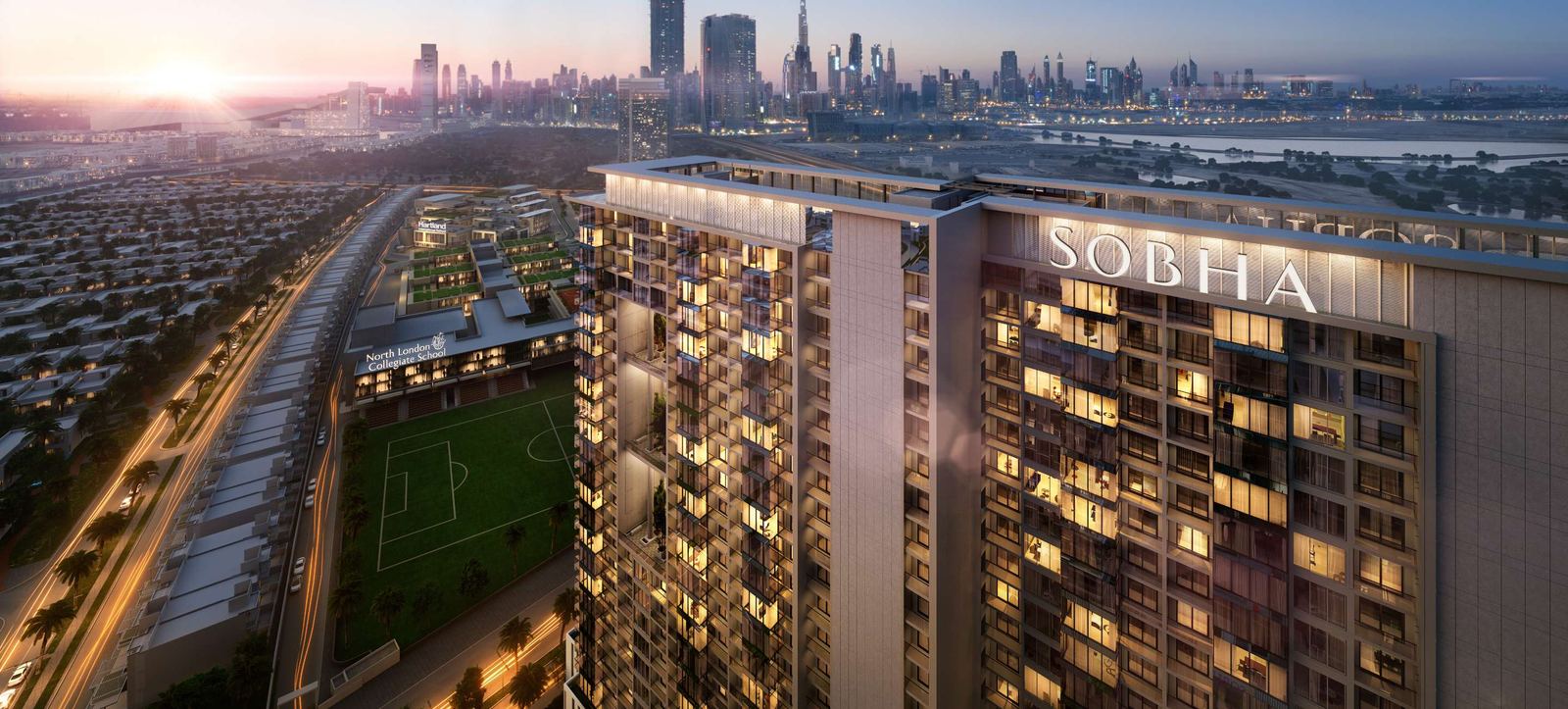 Sobha Hartland at dusk with a Sobha residential tower, villas and green spaces, and the Dubai skyline beyond